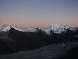 Gokyo Ri 08-1 Everest, Nuptse, Lhotse, Makalu, Cholatse, Tawache From Gokyo Ri Sunset Ends The last rays of the sun highlight Mount Everest and Lhotse, while a warm glow surrounds Nuptse, Makalu, Cholatse, and Taweche. The Nguzumpa Glacier is in shadow below.